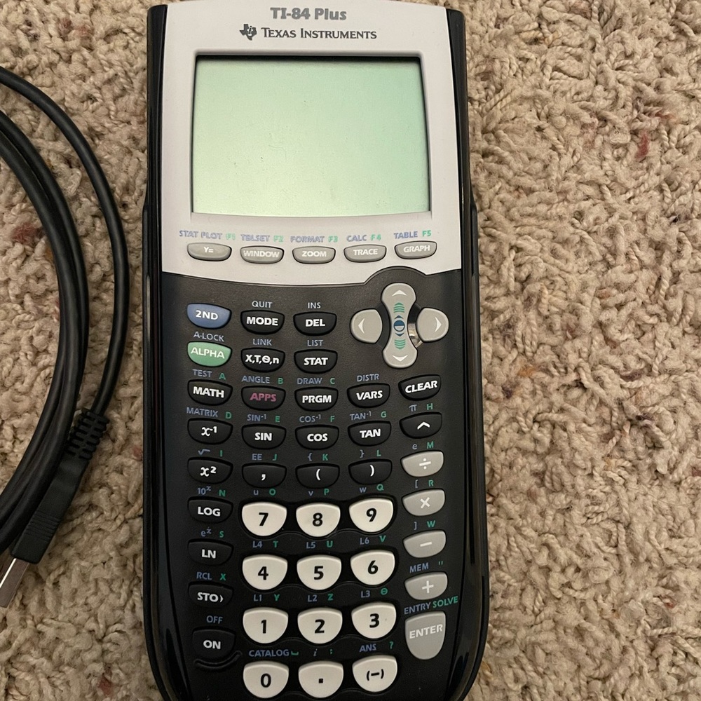 TI-84 PLUS Texas Instruments calculator with charging cord